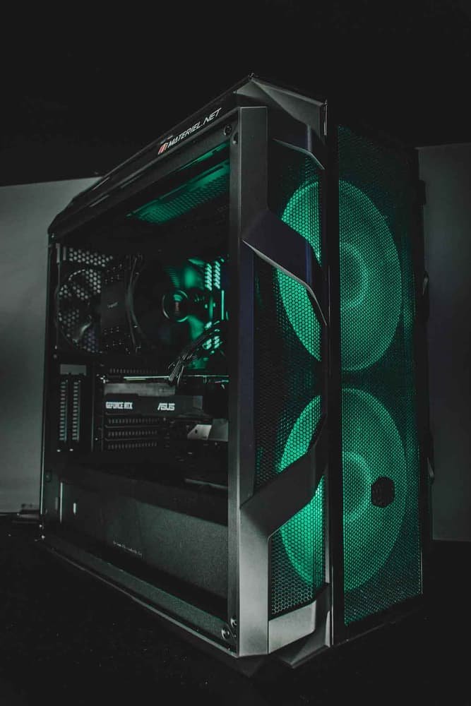 Open PC case with green lit fans